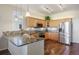 Modern kitchen with stainless steel appliances, granite countertops, and beautiful wood floors create an inviting space for cooking at 5941 S Waco St, Aurora, CO 80016