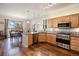 Modern kitchen with stainless steel appliances, granite countertops, and beautiful wood floors create an inviting space for cooking at 5941 S Waco St, Aurora, CO 80016