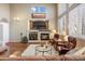 Bright living room features a fireplace, hardwood floors, soaring ceilings, and large windows with lots of natural light at 5941 S Waco St, Aurora, CO 80016