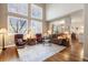 Bright living room features a fireplace, hardwood floors, soaring ceilings, and large windows with lots of natural light at 5941 S Waco St, Aurora, CO 80016