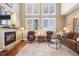 Bright living room features a fireplace, hardwood floors, soaring ceilings, and large windows with lots of natural light at 5941 S Waco St, Aurora, CO 80016
