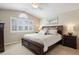 Spacious main bedroom with neutral decor, a large window with plantation shutters, and an arched window at 5941 S Waco St, Aurora, CO 80016