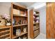Organized pantry features wooden shelves, storage for dry goods and cooking equipment at 5941 S Waco St, Aurora, CO 80016