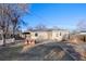 Backyard featuring a brick-paved patio, fire pit, planter boxes and mature trees at 1050 Uvalda St, Aurora, CO 80011