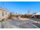 Cozy outdoor area with a brick-paved patio, fire pit, and wood pile at 1050 Uvalda St, Aurora, CO 80011