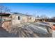 Backyard featuring a brick-paved patio, wood pile and mature trees at 1050 Uvalda St, Aurora, CO 80011
