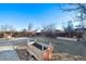 Spacious backyard featuring planter boxes, brick-paved patio and wood pile at 1050 Uvalda St, Aurora, CO 80011