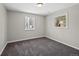 Bedroom featuring neutral walls, carpet floors, and two bright windows at 1050 Uvalda St, Aurora, CO 80011