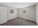 Cozy bedroom with soft carpeting, two bright windows, and neutral colored walls at 1050 Uvalda St, Aurora, CO 80011