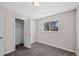Well-lit bedroom featuring new carpeting, closet with an open door, and a window at 1050 Uvalda St, Aurora, CO 80011
