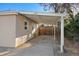 Attached carport featuring a concrete floor and support beams offering sheltered parking at 1050 Uvalda St, Aurora, CO 80011