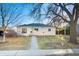 Charming single-story home with a welcoming walkway and a convenient carport at 1050 Uvalda St, Aurora, CO 80011
