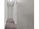 Hallway featuring neutral gray paint, carpet, and classic white doors at 1050 Uvalda St, Aurora, CO 80011
