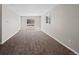 Bright living room featuring neutral paint, carpet flooring, and a front-facing window at 1050 Uvalda St, Aurora, CO 80011