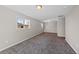 Spacious room with neutral paint, carpet flooring, and natural light from two windows at 1050 Uvalda St, Aurora, CO 80011