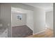 Open room with neutral paint, carpeted area and wood flooring; excellent natural light at 1050 Uvalda St, Aurora, CO 80011