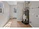 Spacious utility room with window and water heater at 1050 Uvalda St, Aurora, CO 80011