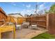 Backyard with gravel area, fire pit, wood fencing, and Adirondack chairs, designed for relaxing and social gatherings at 3034 N High St, Denver, CO 80205