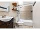 Well-lit bathroom with tiled shower and decorative shelving at 3034 N High St, Denver, CO 80205