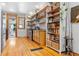 Well-lit kitchen featuring modern appliances, open shelving, and hardwood floors at 3034 N High St, Denver, CO 80205