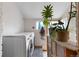 Bright laundry room featuring modern appliances, patterned tile, and lots of natural light from the window at 3034 N High St, Denver, CO 80205
