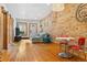 Open living space with brick accent wall, hardwood floors, and comfortable seating at 3034 N High St, Denver, CO 80205