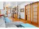 Cozy living room featuring hardwood floors, a comfortable sofa, and modern sliding barn doors at 3034 N High St, Denver, CO 80205