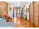 Inviting living room featuring hardwood floors, exposed brick wall, and sliding barn doors at 3034 N High St, Denver, CO 80205