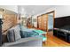 Bright living room showcasing hardwood floors, exposed brick, and an open layout at 3034 N High St, Denver, CO 80205