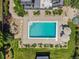 Aerial view of the pool area with landscaping, an outdoor lounge area, and a waterfall feature at 10057 S Shadow Hill Dr, Lone Tree, CO 80124