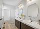 Bright bathroom with double sink vanity, wood-look floors, and subway tiled shower offer comfort and style at 10057 S Shadow Hill Dr, Lone Tree, CO 80124