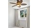 Cozy bedroom boasts modern ceiling fan, light walls, and bright window with view of surrounding nature at 10057 S Shadow Hill Dr, Lone Tree, CO 80124