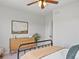 Neutral bedroom with bed, wooden dresser, decorative plant, and stylish artwork creates a calming retreat at 10057 S Shadow Hill Dr, Lone Tree, CO 80124