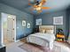 Blue bedroom with carpet, fan, and two windows at 10057 S Shadow Hill Dr, Lone Tree, CO 80124