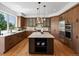 Beautiful kitchen with modern appliances, a center island, stylish cabinets, and hardwood floors at 10057 S Shadow Hill Dr, Lone Tree, CO 80124