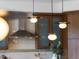 Bright kitchen featuring custom cabinets, modern lighting, and stainless hood at 10057 S Shadow Hill Dr, Lone Tree, CO 80124