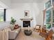 Cozy living room with a fireplace, a large window, and plenty of natural light at 10057 S Shadow Hill Dr, Lone Tree, CO 80124