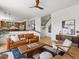 Open living room with hardwood floors, and access to kitchen and staircase at 10057 S Shadow Hill Dr, Lone Tree, CO 80124