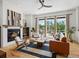 Inviting living room with fireplace, large windows and access to outdoor deck at 10057 S Shadow Hill Dr, Lone Tree, CO 80124