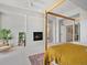 Bright main bedroom with accent wall fireplace and a decorative wooden framed bed at 10057 S Shadow Hill Dr, Lone Tree, CO 80124