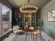 Home office with gray walls, chandelier, large window and built-in shelving at 10057 S Shadow Hill Dr, Lone Tree, CO 80124