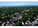 Neighborhood aerial view showcasing tree-lined streets and varied home styles under a bright sky at 3512 Wyandot St, Denver, CO 80211
