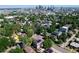 Stunning aerial view of the community with lush greenery and a cityscape backdrop for the home at 3512 Wyandot St, Denver, CO 80211