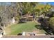 An overhead view shows the lush backyard with mature trees, green grass, a wooden fence, and a small shed at 3164 S Nucla St, Aurora, CO 80013