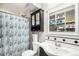 Cozy bathroom featuring black and white tiling, a tiled walk-in shower, and vanity storage at 3164 S Nucla St, Aurora, CO 80013