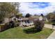 Aerial shot showcasing well-kept lawn and inviting front porch of this charming single-Gathering home at 3164 S Nucla St, Aurora, CO 80013