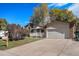 View of the front exterior showcasing the charming brick facade, well-kept lawn, and two car garage at 3164 S Nucla St, Aurora, CO 80013