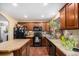 Well-equipped kitchen with dark cabinets, granite countertops and island at 3164 S Nucla St, Aurora, CO 80013