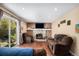 Bright living room with stone fireplace, hardwood flooring, and sliding glass door that leads to the backyard at 3164 S Nucla St, Aurora, CO 80013