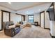 Finished basement with a comfortable seating area, fireplace, and a sliding barn door at 11932 Coal Creek Heights Dr, Golden, CO 80403